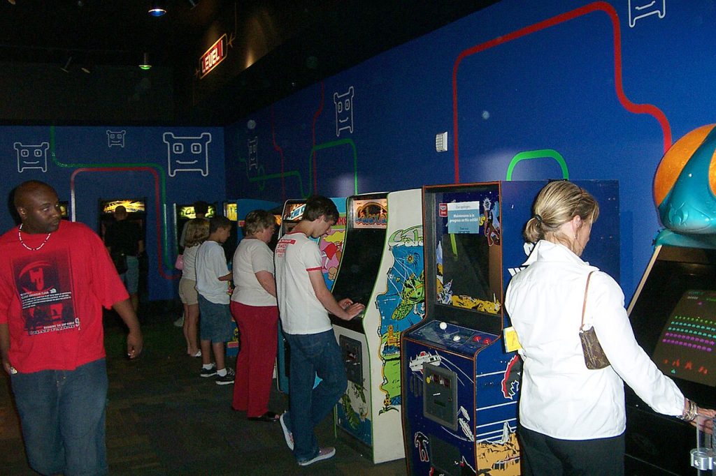 A row of colourful arcade game machines offering different game categories
