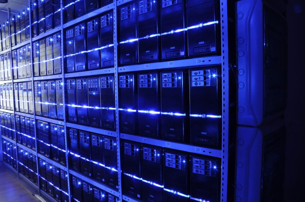 engineer walking between data centre server racks