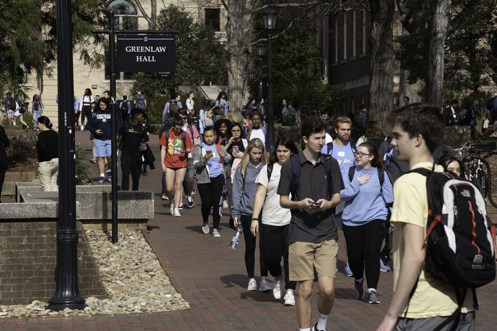 Students walking across a university campus between classes
