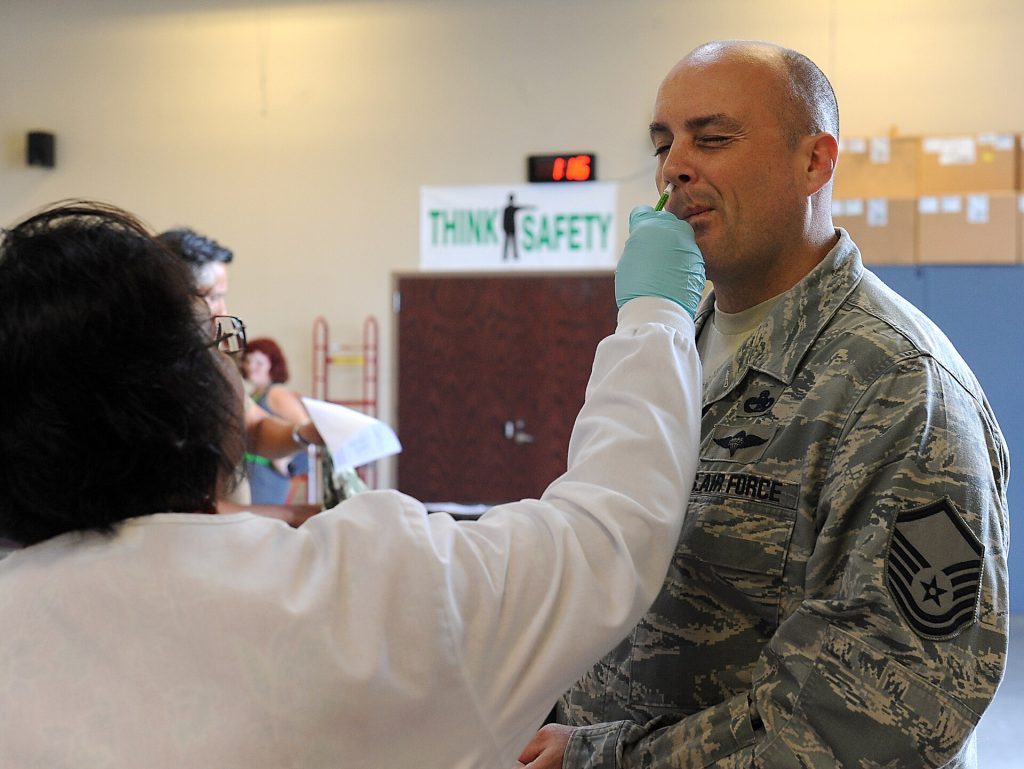 Healthcare worker preparing a measles vaccination for a patient